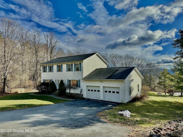 view of front of house featuring a garage and a front lawn