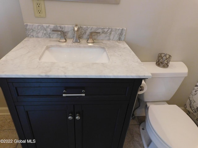 bathroom featuring tile patterned floors, vanity, and toilet