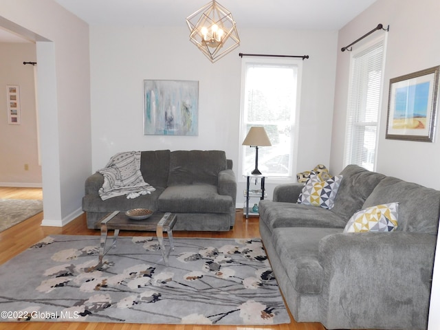 living room featuring an inviting chandelier and hardwood / wood-style flooring