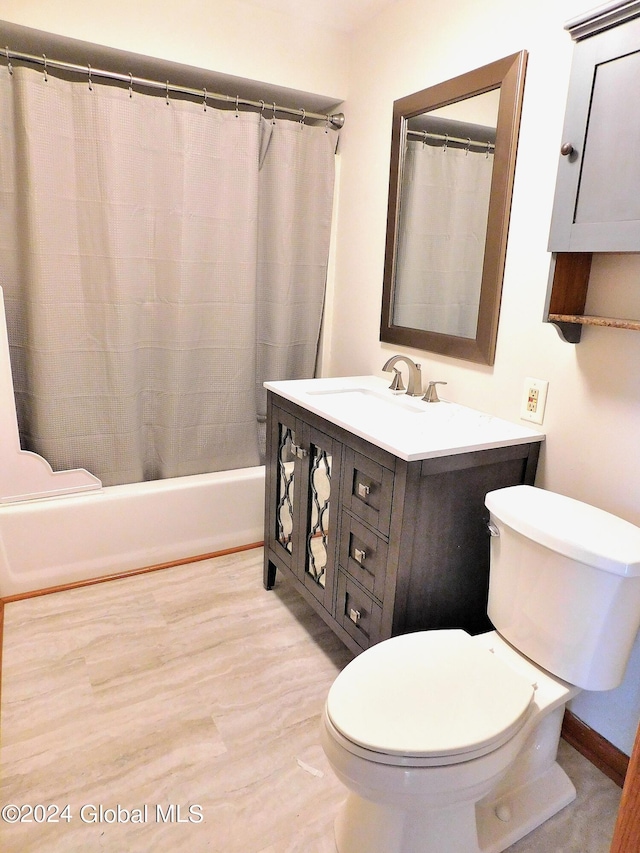 full bathroom featuring vanity, shower / tub combo, and toilet