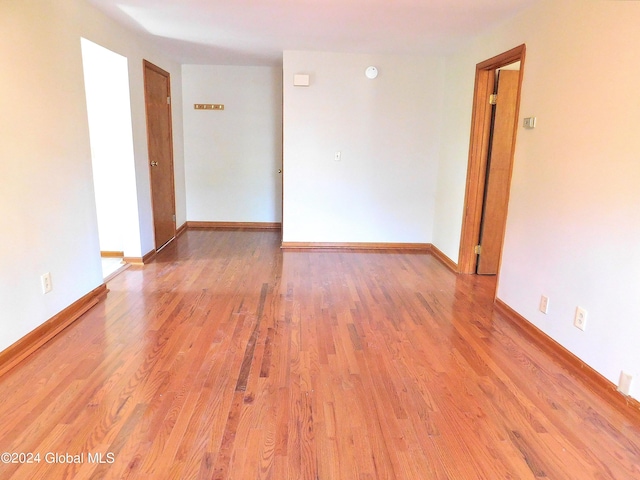 unfurnished room with light wood-type flooring