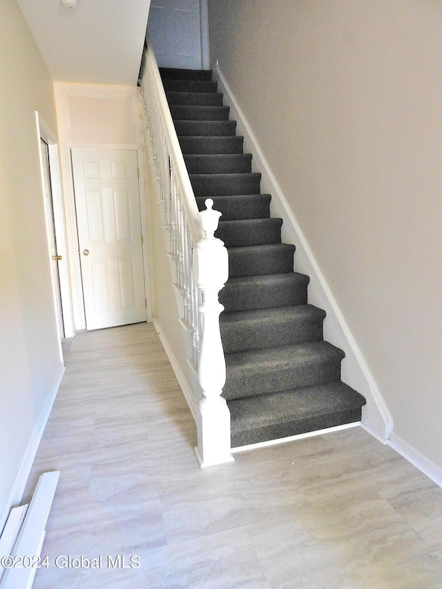 stairs with wood-type flooring