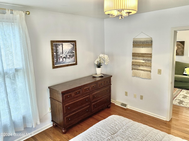 bedroom with dark hardwood / wood-style floors