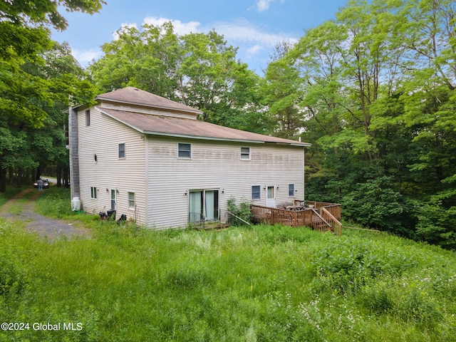 back of property with a wooden deck