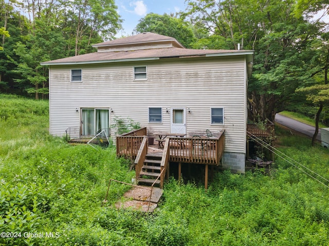 rear view of house featuring a deck