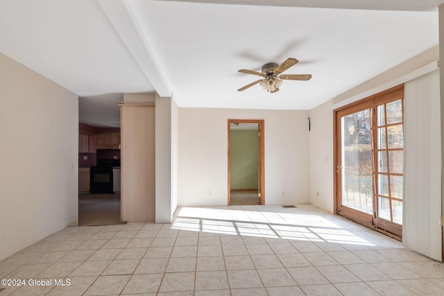 tiled spare room with ceiling fan