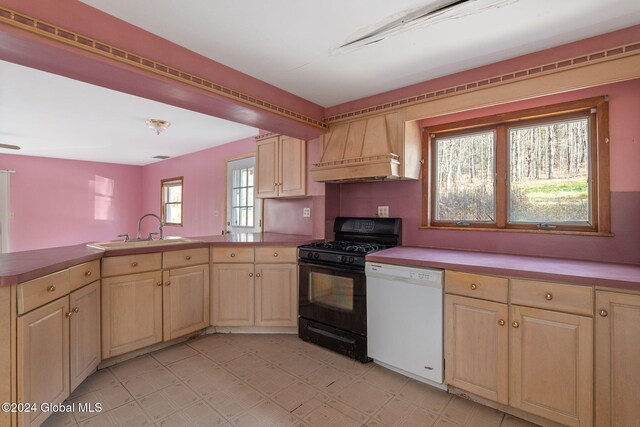 kitchen with black gas range, sink, kitchen peninsula, white dishwasher, and custom exhaust hood