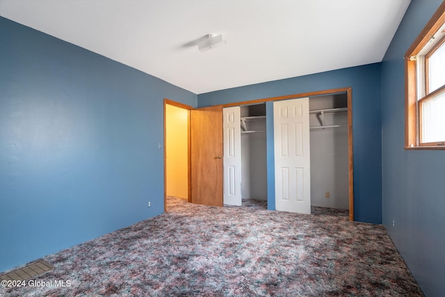 unfurnished bedroom with a closet and carpet