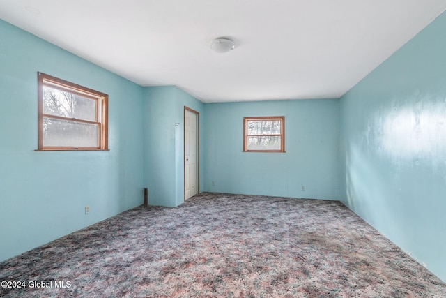 carpeted empty room with plenty of natural light