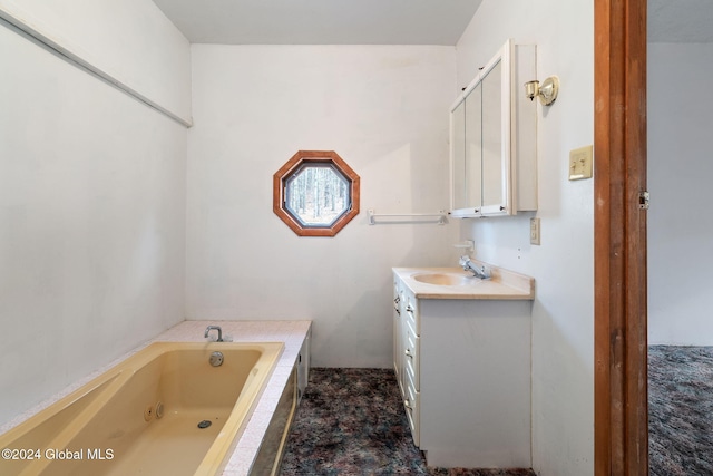 bathroom featuring vanity and a relaxing tiled tub