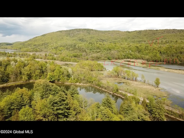 drone / aerial view featuring a water and mountain view