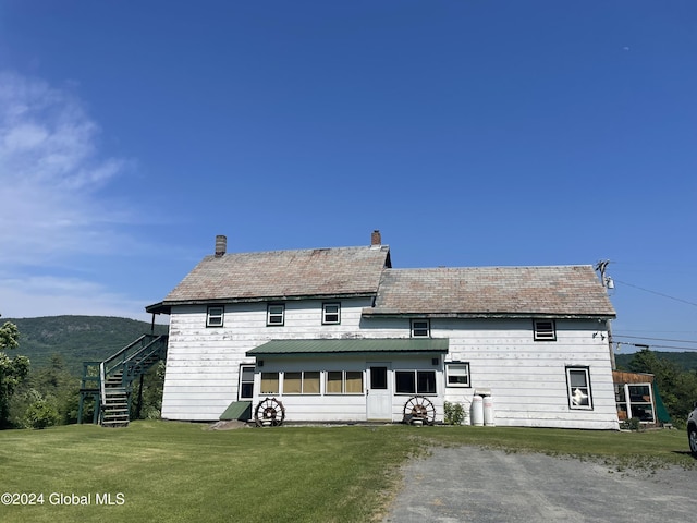 rear view of house with a lawn