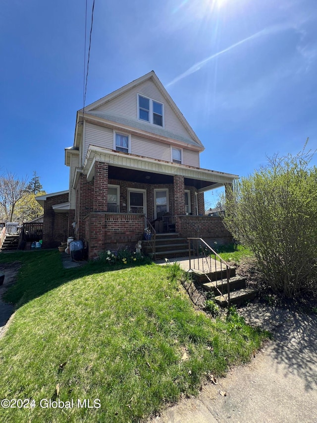 view of front facade with a front lawn and a porch