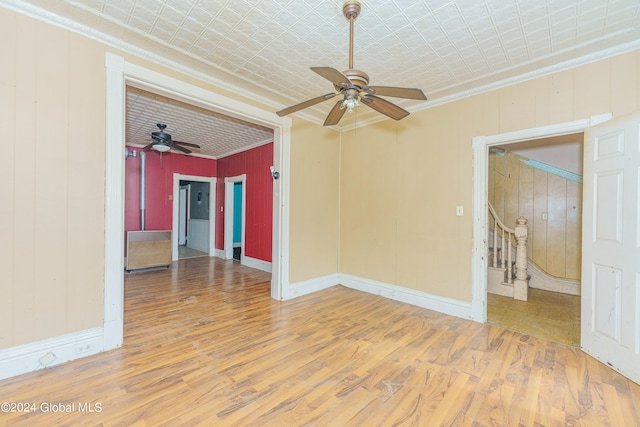 spare room with ceiling fan, hardwood / wood-style flooring, and ornamental molding