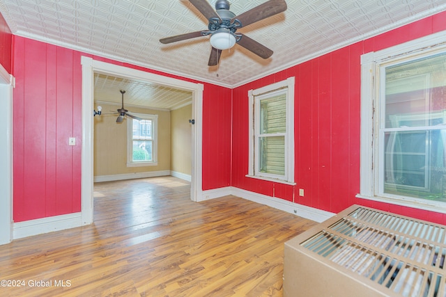 unfurnished room with light wood-type flooring, crown molding, and ceiling fan