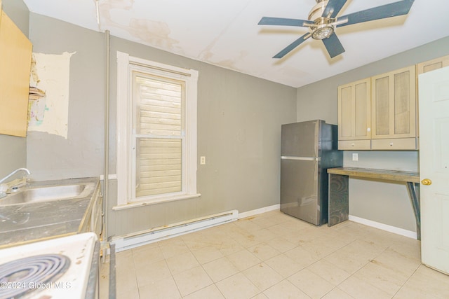 kitchen featuring stainless steel refrigerator, white stove, light brown cabinetry, sink, and a baseboard heating unit