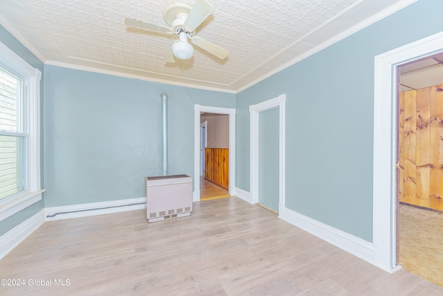 empty room with ceiling fan, light wood-type flooring, and crown molding