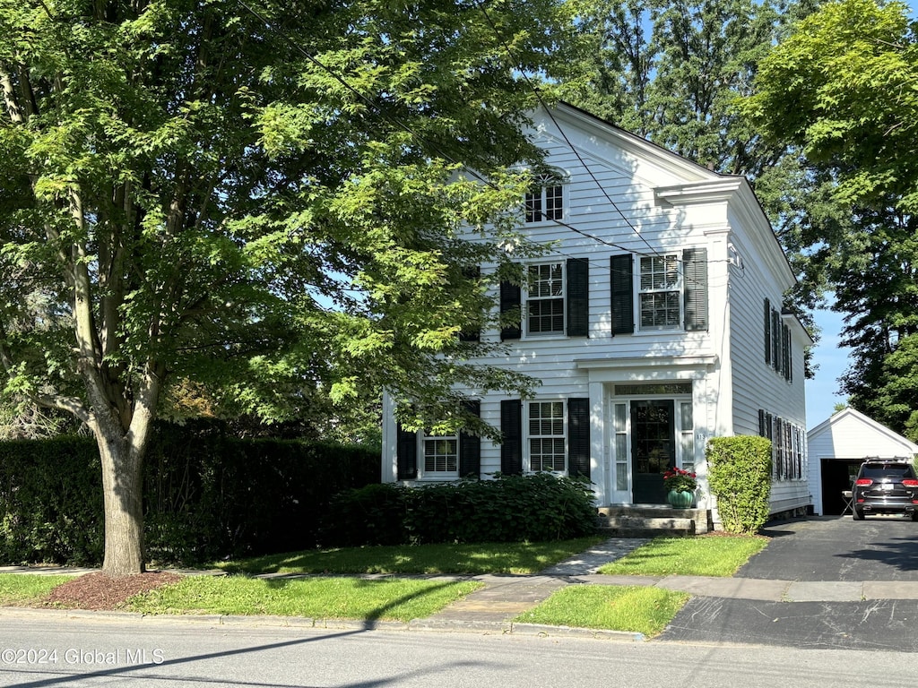 view of front facade featuring an outbuilding and a garage