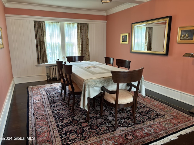 dining room with dark wood-type flooring, radiator, and ornamental molding