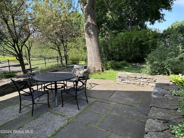 113 S William St, Johnstown, NY 12095 - view of patio with outdoor dining area and fence