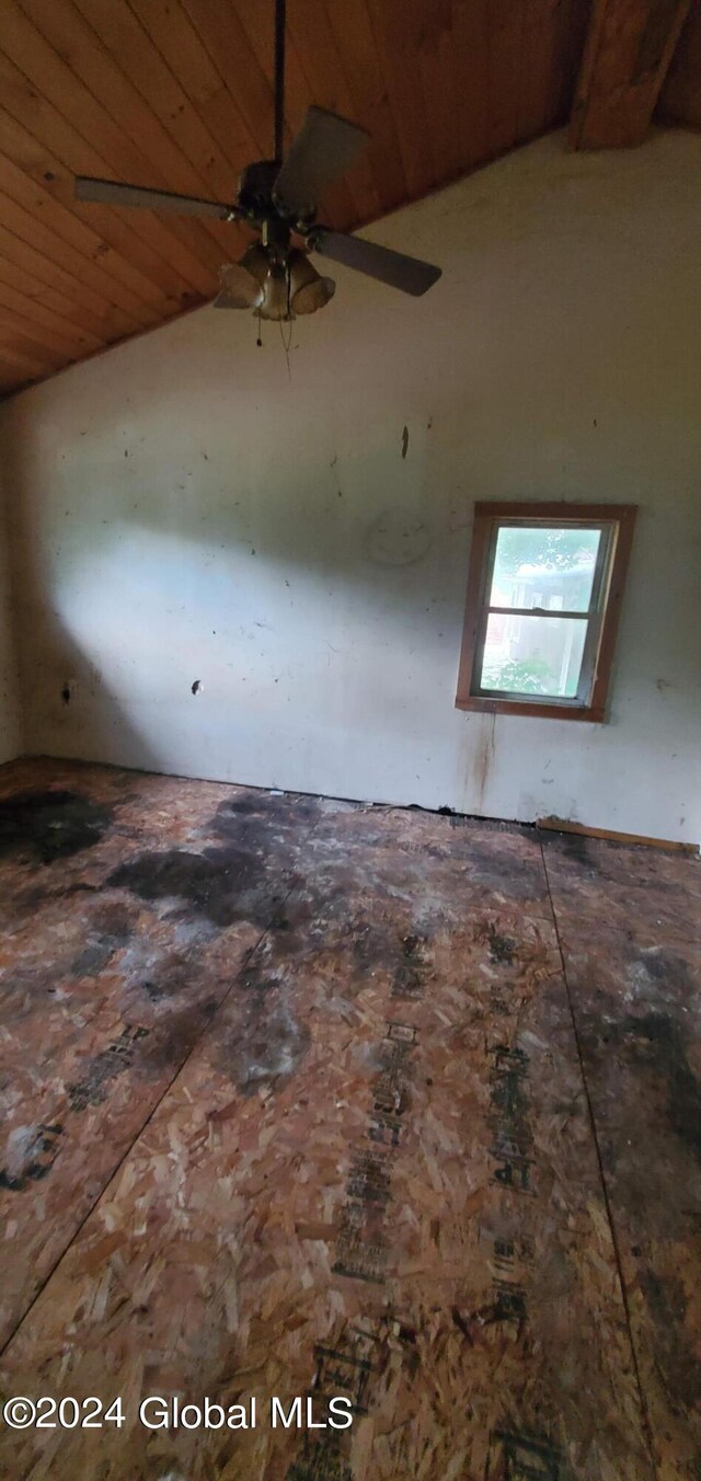 empty room featuring wooden ceiling, lofted ceiling, and ceiling fan