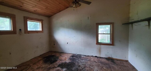 spare room with a healthy amount of sunlight, vaulted ceiling, ceiling fan, and wood ceiling