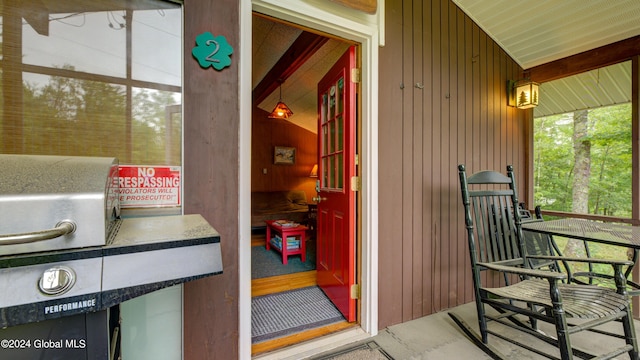 view of exterior entry with a porch