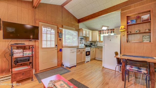 kitchen featuring white appliances, wood walls, and light wood-style floors
