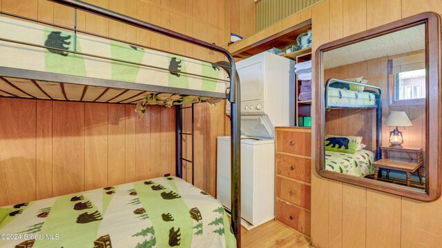 2769 State Route 8 # 2, Speculator, NY 12164 - bedroom featuring estacked washer and dryer, wooden walls, and wood finished floors