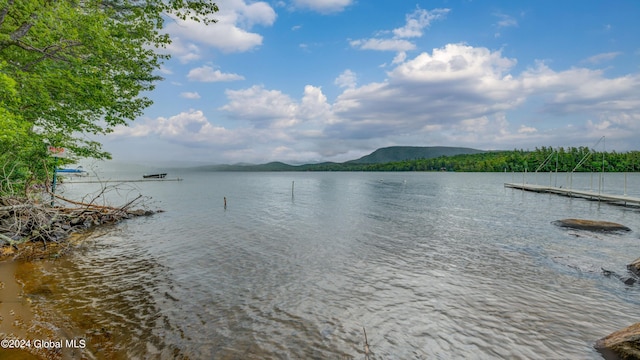 water view featuring a dock and mountains