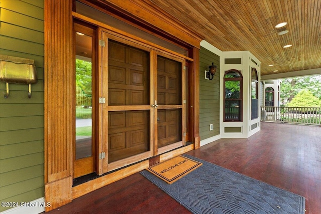 view of exterior entry featuring a porch