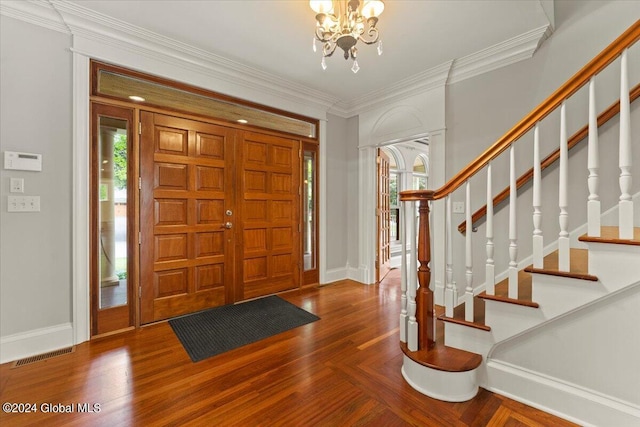 foyer featuring a notable chandelier, ornamental molding, and wood-type flooring