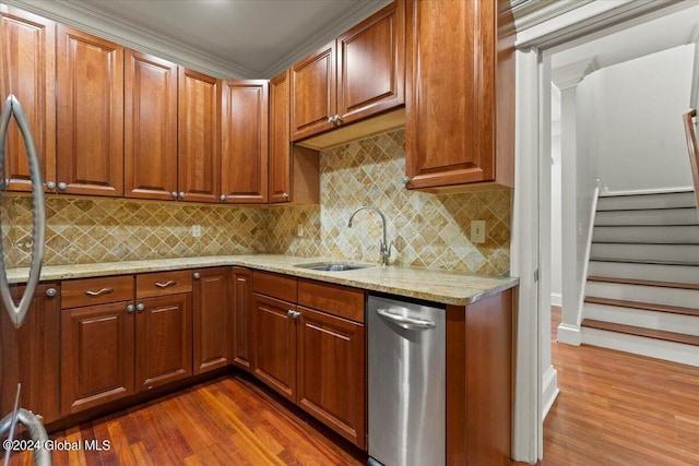 kitchen with backsplash, light stone countertops, sink, and dark hardwood / wood-style floors