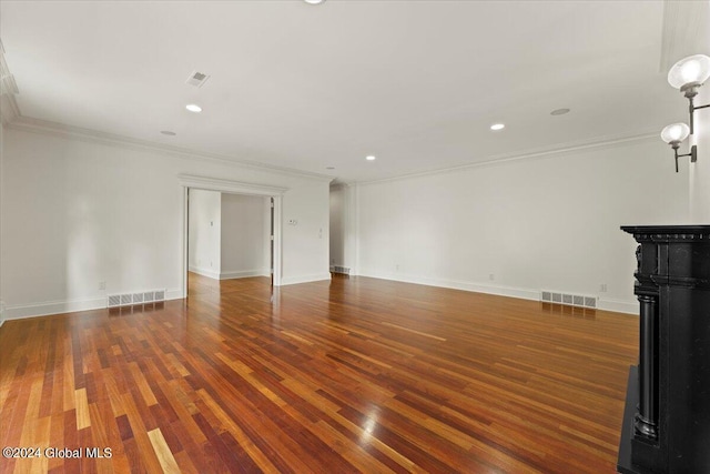 unfurnished living room with dark wood-type flooring and ornamental molding