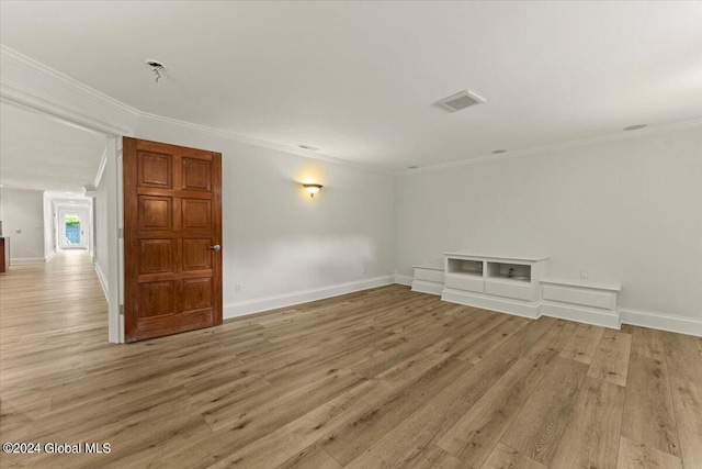 unfurnished room with crown molding and light hardwood / wood-style floors