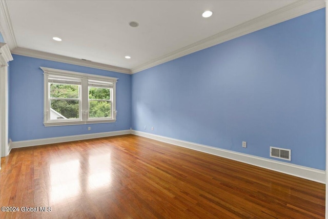 unfurnished room featuring crown molding and wood-type flooring