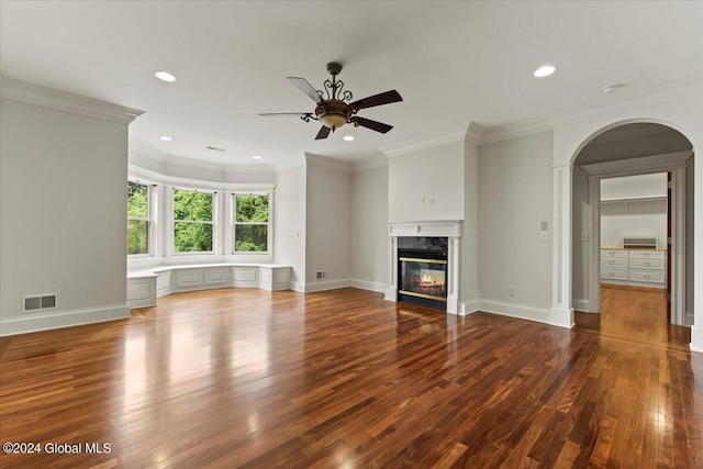 unfurnished living room with crown molding, a high end fireplace, dark hardwood / wood-style floors, and ceiling fan