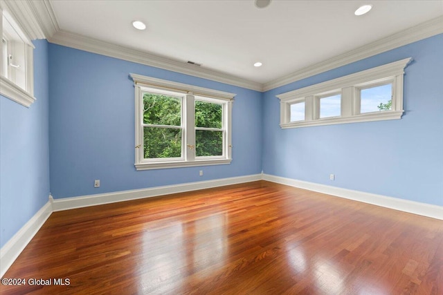 unfurnished room with crown molding and wood-type flooring