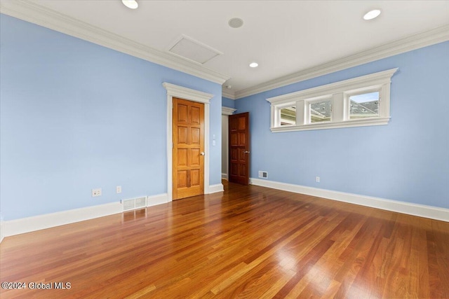 unfurnished room featuring ornamental molding and wood-type flooring