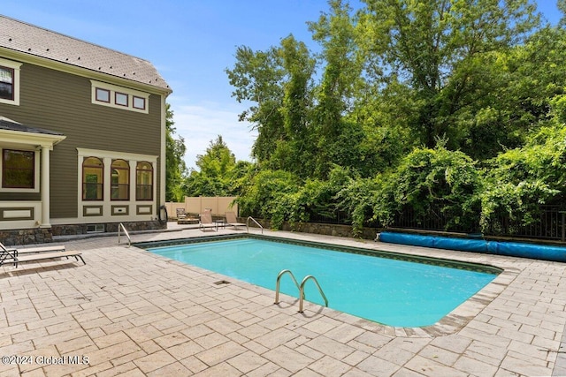 view of swimming pool featuring a patio area