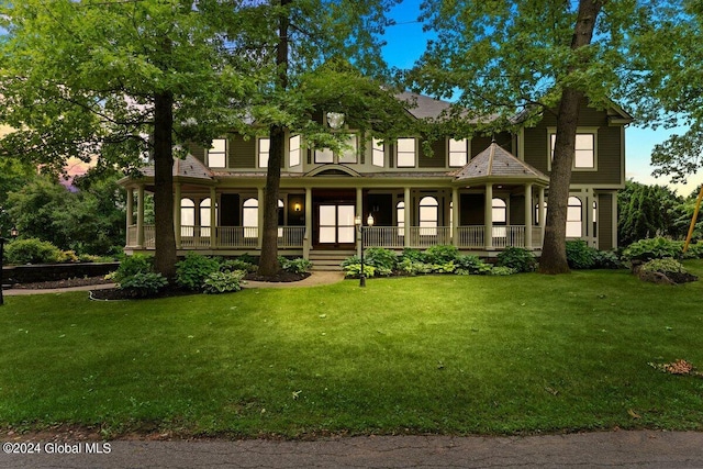 view of front of home featuring a lawn and covered porch