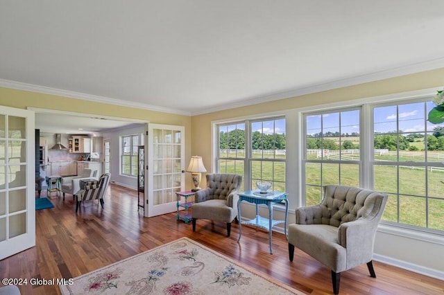 sitting room with ornamental molding, french doors, and dark hardwood / wood-style floors