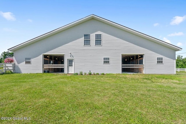 back of property featuring a yard