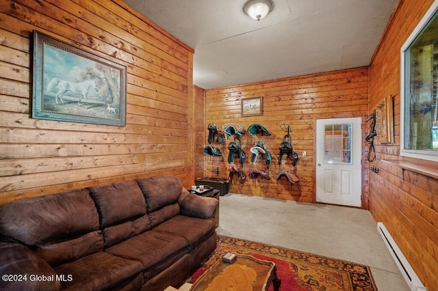 carpeted living room with wooden walls and a baseboard radiator