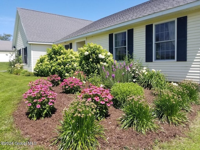 view of side of home with a lawn