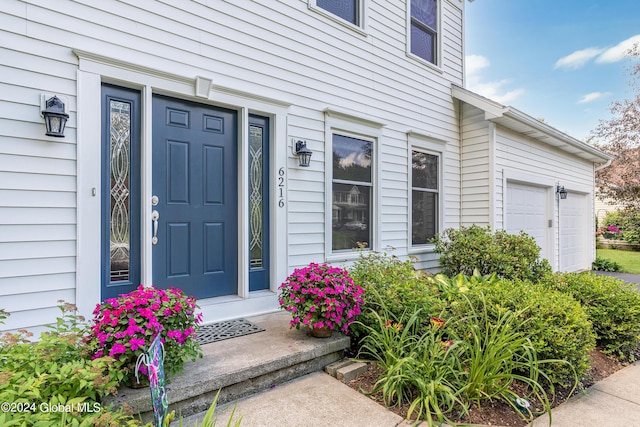 property entrance featuring an attached garage