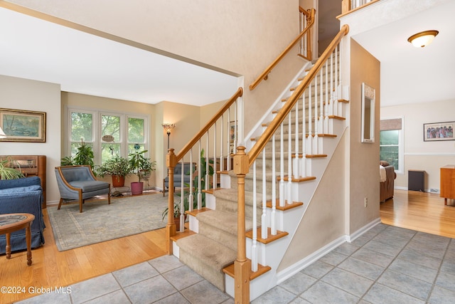 staircase with tile patterned floors and baseboards