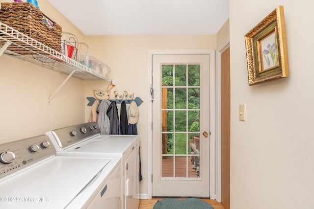 laundry room featuring baseboards, laundry area, washing machine and dryer, and a healthy amount of sunlight
