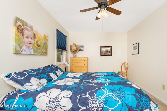 carpeted bedroom with baseboards and a ceiling fan