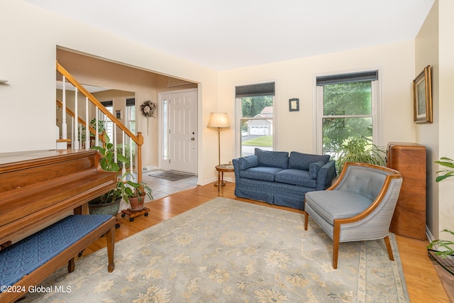 living area with stairs and wood finished floors